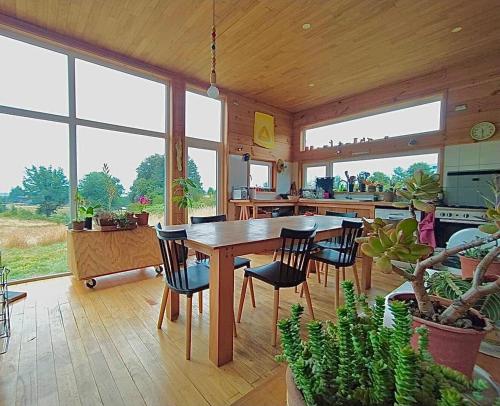 a dining room with a table and chairs in a house at Casa Azul Frutillar in Frutillar