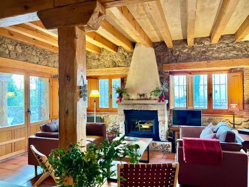 a living room filled with furniture and a fireplace at Saltus Abus, conjunto rural con encanto en Sotosalbos, 15min de Segovia in Sotosalbos