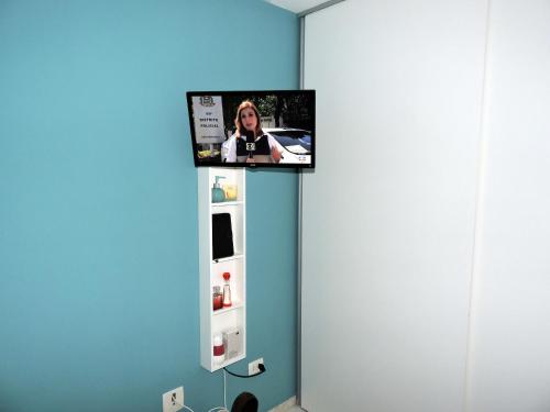 a flat screen tv above a refrigerator in a room at 10 Studios in Sao Paulo