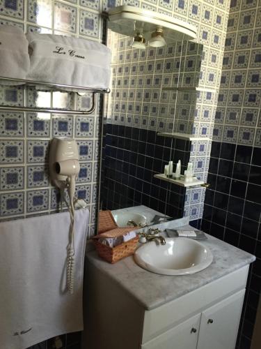 a bathroom with a sink and a phone at La Casona Minera in Mineral de Pozos