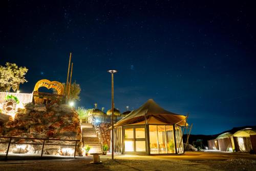 a building at night with a street light at Glamping El Refugio in Archidona