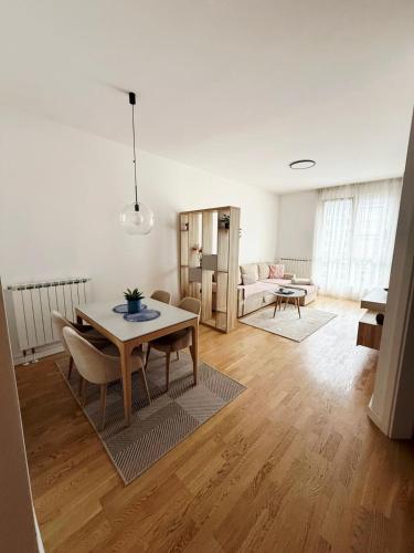 a living room with a table and a couch at Bulevar Pent in Sarajevo