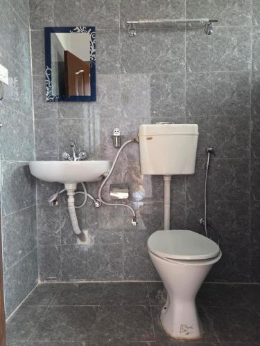 a bathroom with a toilet and a sink at Pahaad Ko Ghaar in Nagarkot