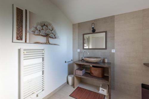 a bathroom with a sink and a mirror at L'air de Riez in Saint-Hilaire-de-Riez