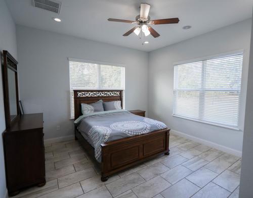 a bedroom with a bed and a ceiling fan at Pondfront Ranch • Theater Room • Sleeps 8 in Eagle Lake