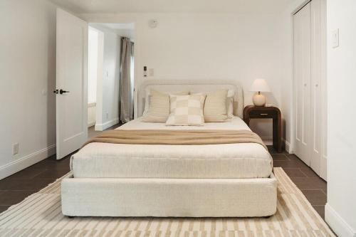 a white bedroom with a large bed in a room at Beachside Bliss - Beach House Unit 2 in Jacksonville Beach
