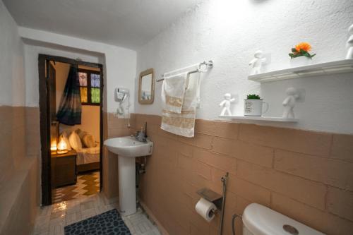a bathroom with a sink and a toilet at Jnan Dar Sbil in Fès