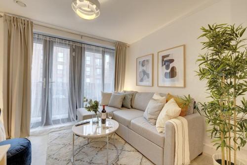 a living room with a couch and a table at Lovely Flat in Kiln Close with Free Parking in Gloucestershire
