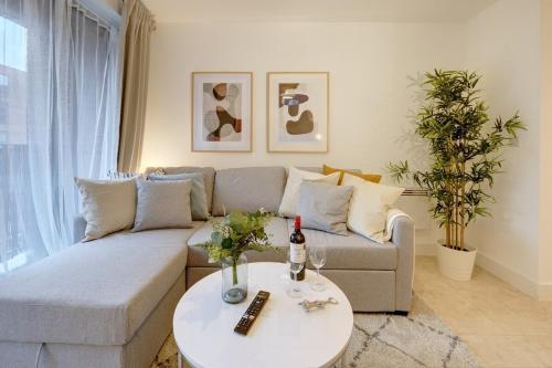 a living room with a couch and a table at Lovely Flat in Kiln Close with Free Parking in Gloucestershire
