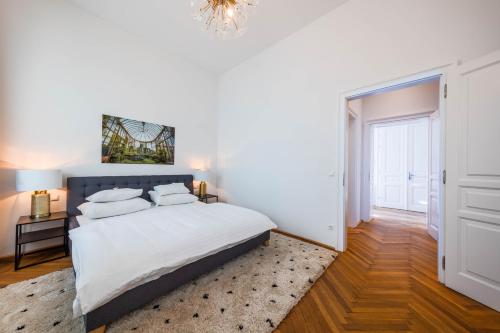 een slaapkamer met een bed en een kroonluchter bij Smile Apartments am Stadtpark in Krems an der Donau