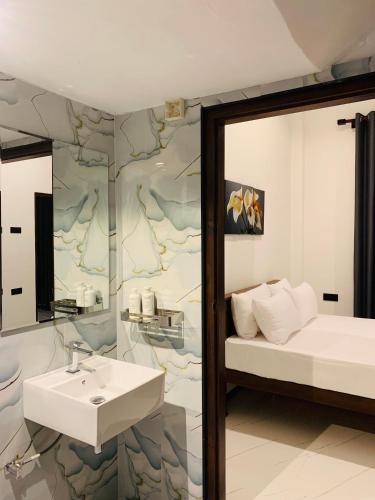a bathroom with a sink and a mirror at Dasis villa in Hiriketiya