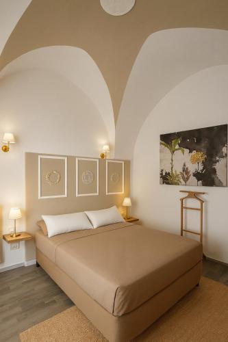 a bedroom with a large bed and two lamps at leuca bis house in Lecce