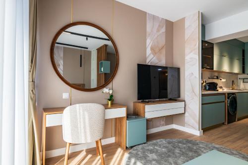 a living room with a mirror and a chair at Best Residence - High-End Suites - by Solinis Homes in Bucharest
