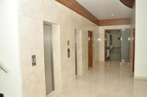 a hallway of a building with a wall of tile at Palguni Residency in Hassan