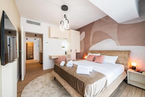 a bedroom with a large bed with pink pillows at Best Residence - High-End Suites - by Solinis Homes in Bucharest