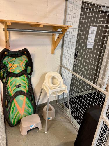 a bird cage with a suitcase and a stool at Ylläs Chalets 7305 in Ylläs