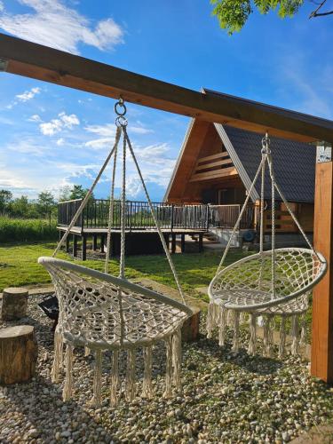 two swings in front of a house at Tomina Koliba Lika in Sveti Rok