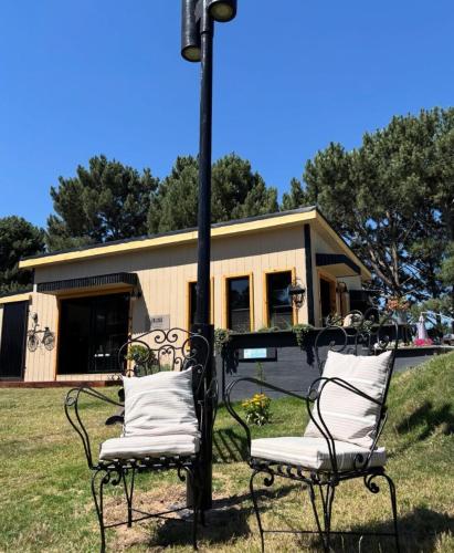 a couple of chairs sitting in front of a house at Posada Bliss in Punta del Este