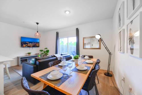 a dining room with a table and chairs and a living room at Spacious Townhouse W Free Parking in Miami