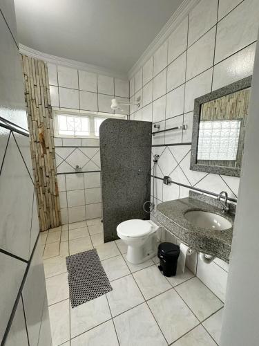 a bathroom with a toilet and a sink at Hotel Monte Carlo - Cáceres in Cáceres