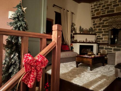 a living room with a christmas tree and a fireplace at Cozy Nest House Δίκορφο Ζαγορίου in Dikorfo