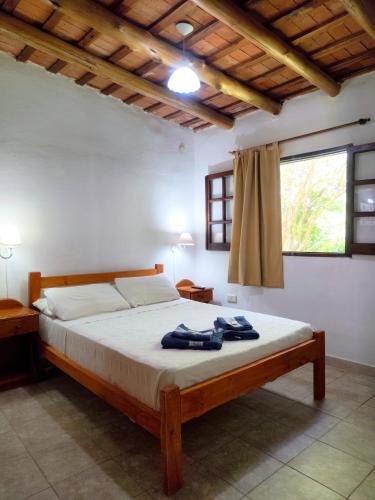 a bedroom with a bed in a room at Mirador del lago apart y cabañas- exclusivo adultos in Las Rabonas