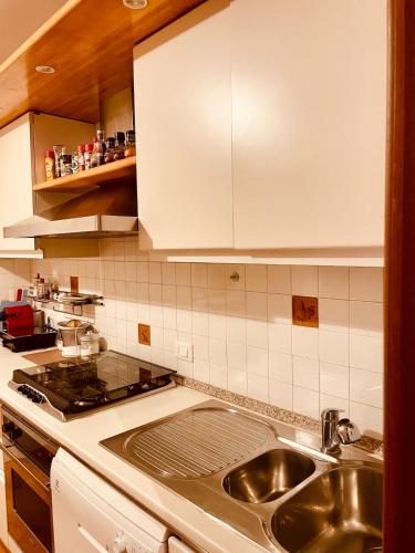 a kitchen with a sink and a counter top at Attico in centro in Udine