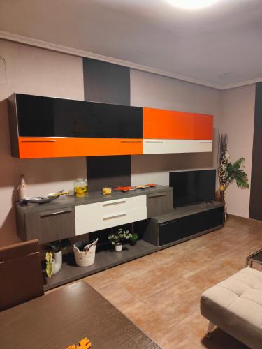 a living room with a large entertainment center at Nuria's home in Calanda