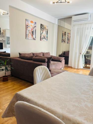 a living room with a couch and a table at Sunshine in Budva