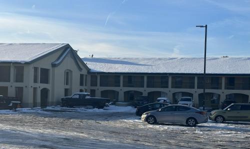 a snow covered building with cars parked in a parking lot at Red Roof Inn Media, PA in Media