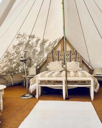 a bedroom with a bed in a tent at Cortijo Bablou in Arcos de la Frontera