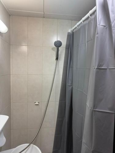 a shower with a shower curtain in a bathroom at SN REAL ESTATE HOME in Abu Dhabi