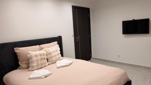 En eller flere senge i et værelse på T4 Luxe