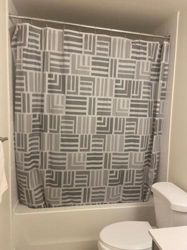 a shower curtain in a bathroom with a toilet at Modern Private Room with Ensuite in Vaughan