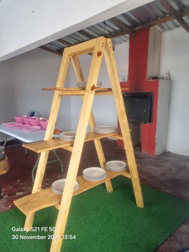 a wooden ladder with plates on it in a room at Vegas guest house in Dwarsloop