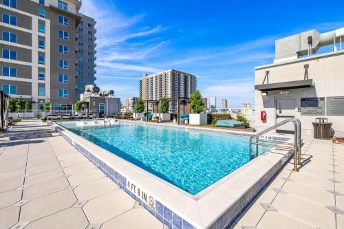 an image of a swimming pool at a building at Elegant 1BR Walkable to Dining, Pool + Gym in Tampa