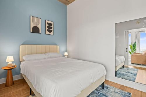 a bedroom with a large white bed and a window at 1BR Channelside | Free Amenities + Prime Location in Tampa