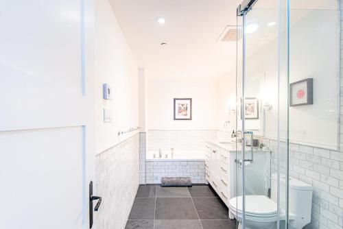 a bathroom with a glass shower and a toilet at Altitude Ski-in Out at Resort with Private Hottub in Mont-Tremblant