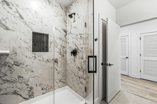 a bathroom with a shower with a glass door at Chic Channelside Getaway in DT | Close to DT! in Tampa