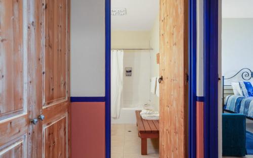 a room with a door and a bedroom at Casita Alegre - Clifftop Stay Above Knight Beach in Port Elliot