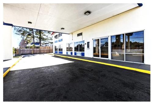 an empty parking lot in front of a building at Family Inns of America - Mobile in Mobile