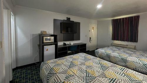 una camera d'albergo con due letti e una televisione di Motel 6 - Lamesa, TX a Lamesa