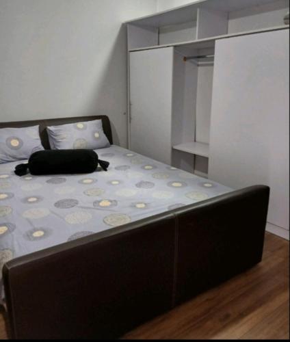 a bed in a small room with a black pillow on it at Stan na dan Ugljevik Centar in Ugljevik
