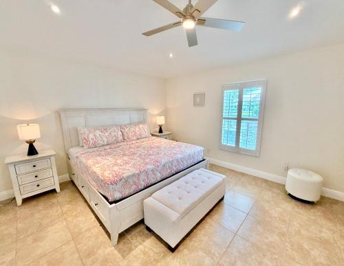 een slaapkamer met een bed en een plafondventilator bij Villa Charming in Cape Coral