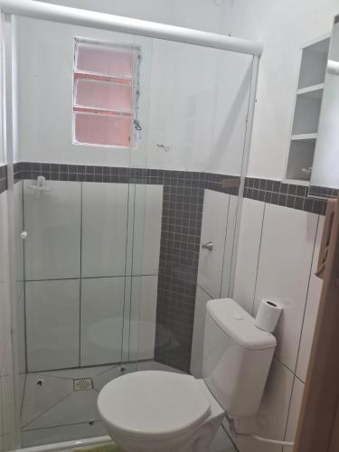 a bathroom with a toilet and a glass shower at Casa Torres in Torres