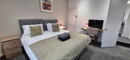 een slaapkamer met een bed met een tas erop bij St Johns - 2 Bed House in Balby