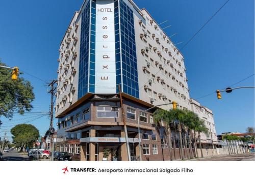 a tall building with a sign on the side of it at Hotel Express Aeroporto in Porto Alegre