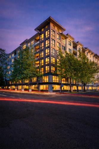 a large building with windows on a street at night at The Manor - Alexandria in Alexandria