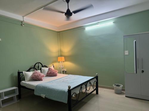 a bedroom with a bed with pink pillows and a ceiling at Humble abode Homestay 1BHK with scenic view in Itānagar