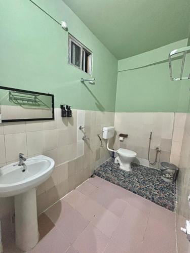 a bathroom with a sink and a toilet at Humble abode Homestay 1BHK with scenic view in Itānagar